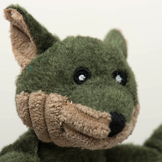 Close up of olive green fox's face to show embroidery details and fabric texture.