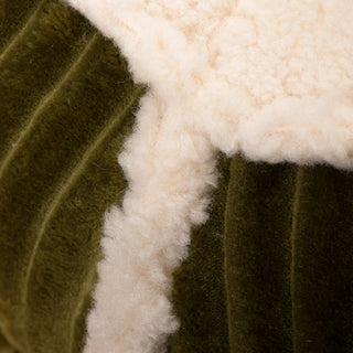 Close up view of where the olive green corduroy fabric meets the fleece fabric sleeping area to show texture of both fabrics.