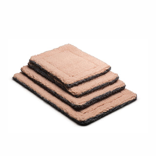 Stack of dusty rose and gray colored mats in various sizes.