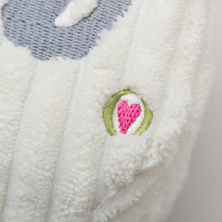 Close-up of a textured fabric with a heart design on a white background