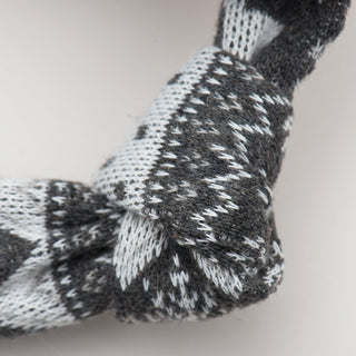 Close up image of the the knotted limb on the festive fox plush dog toy.