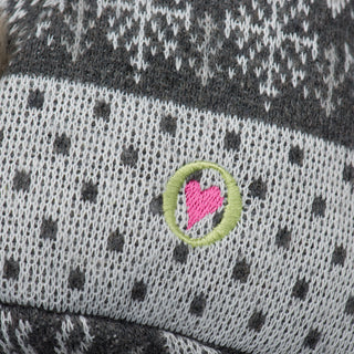 Close up image of the HuggleGroup logo on the festive fox plush dog toy. 