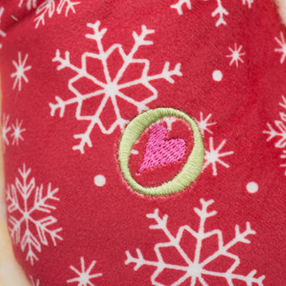 Close up image of HuggleGroup logo on the front of bone shaped Christmas themed plush. 