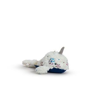 Small narwhal with white faux-fur with shiny metallic rainbow snowflake design, gray horn, blue corduroy belly, and a knotted tail.