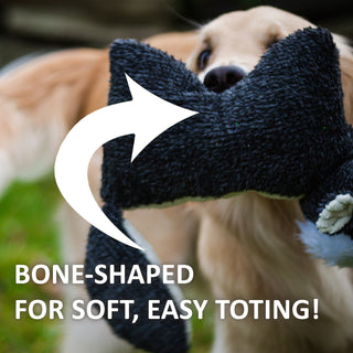 Dog holding Squooshie™ plush dog toy in mouth with text "Bone-shaped for soft, easy toting!"