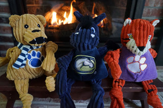 Set of three University mascot durable plush corduroy dog toys with knotted limbs: Penn State, California Davis, and Clemson.