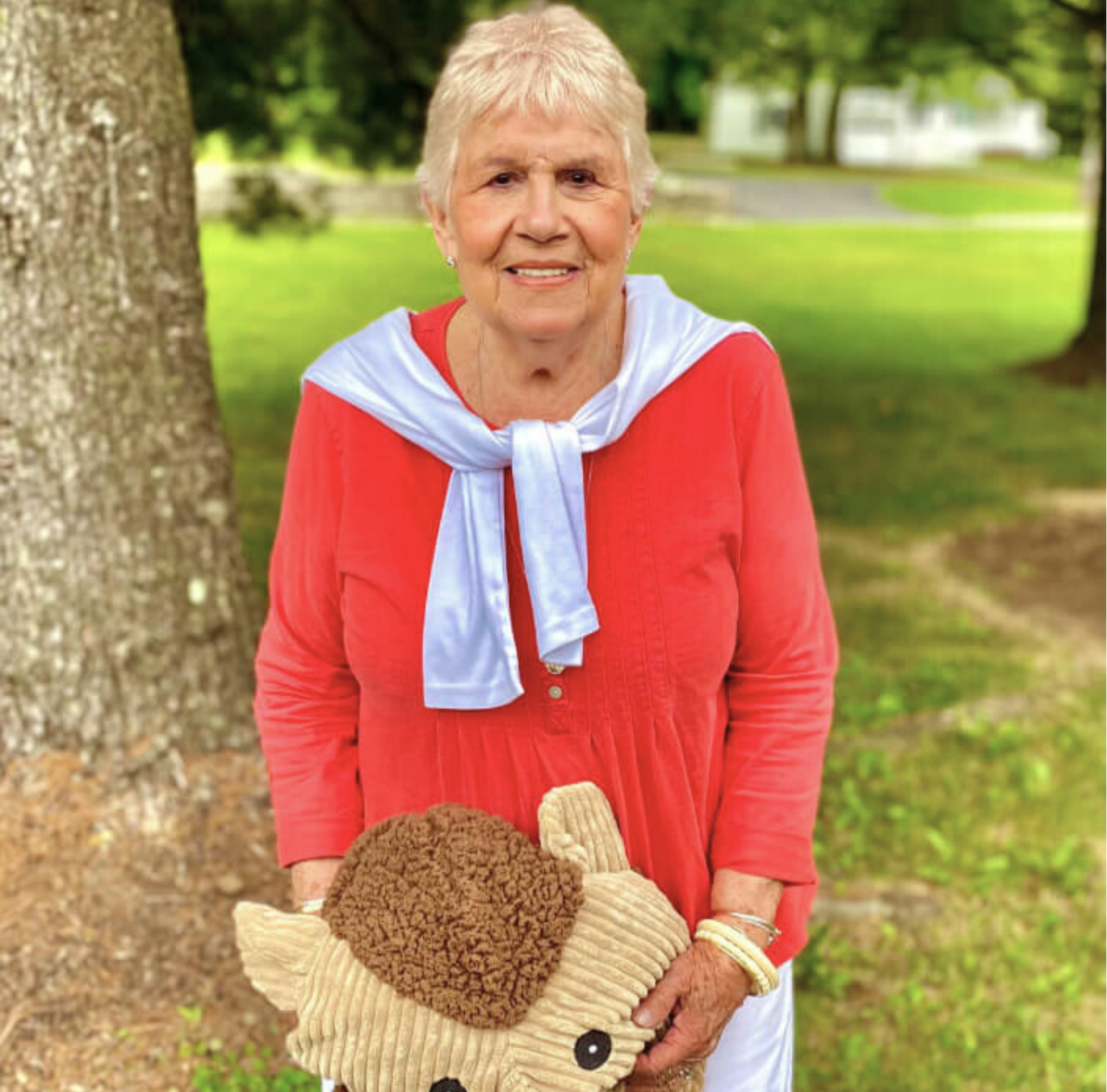 Edi Krauss, Sales Specialist, posed with giant plush Hedgehog Knottie® toy.