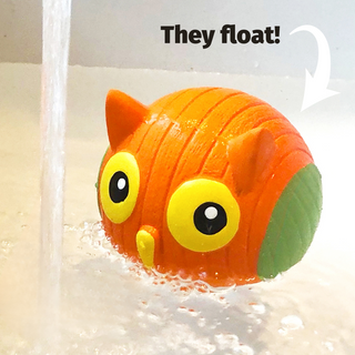 Ruff-Tex® squeaky ball dog toy floating in water with text "They float!"