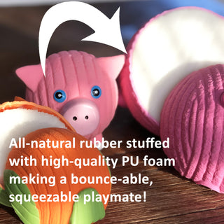 Close up of latex Ruff-Tex® squeaky ball dog toys cut in half to show stuffing inside. Text reads "All-natural rubber stuffed with high-quality PU foam making a bounce-able, squeezable playmate!"