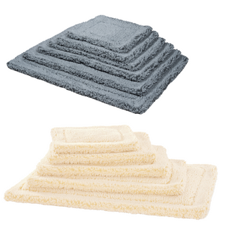 two stacks of HuggleFleece mats.  One is gray and one is a natural colored stack of mats.