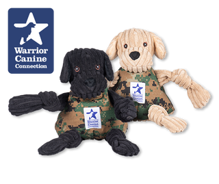 Warrior Canine Connection logo next to black and yellow lab plush Knottie® dogs