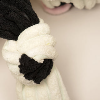 Close up image of knotted limb with black polka dot, on Jonny Justice durable plush corduroy dog toy.