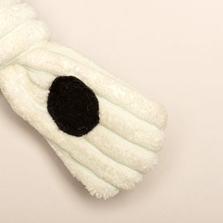 Close up image of white paw with black polka dot, on Jonny Justice durable plush corduroy dog toy. 