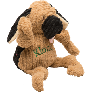 Side view of Blood Hound durable plush fuzzy corduroy dog toy with squeakers, tan fur, knotted limbs, black corduroy ears and snout, long cream colored inner ears, and pink tongue sticking out with name "Klondike" embroidered in green across chest.