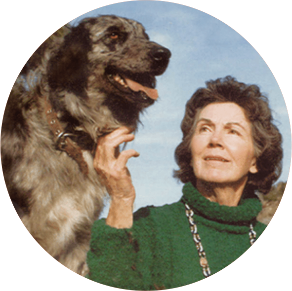 An image with a women next to a dog