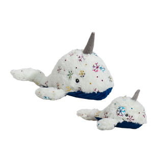 Set of two narwhal-shaped durable plush dog toys in large and small: both have white faux-fur with shiny metallic rainbow snowflake design, gray horn, blue corduroy belly, and a knotted tail.