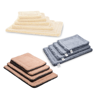 Stacks of the various colorways and sizes of HuggleFleece® mats available; natural, gray, dusty rose & gray.