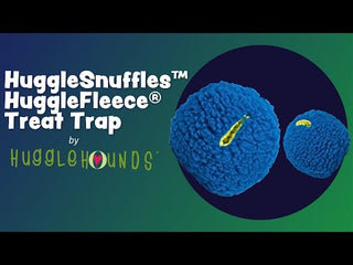 Promotional video for HuggleHounds Treat Trap toy, showing a plush treat-dispensing ball in use by dogs, with close-ups of design features and branding overlays.