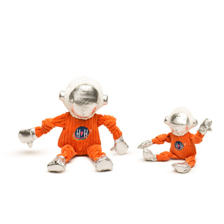 Two toy figures in orange outfits with silver helmets on a white background