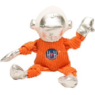 Toy figure with silver head and limbs wearing an orange sweater with a logo on a white background