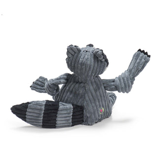 Back of raccoon shaped plush dog toys: has a gray-blue furred head, body, and knotted limbs, black claws, with gray-blue and black striped tail. 