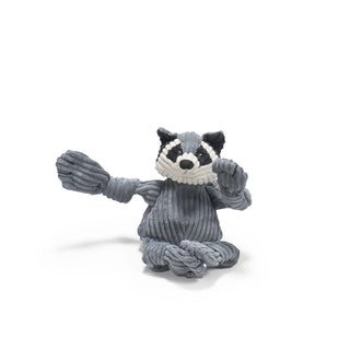 Raccoon shaped plush dog toy: has black, gray-blue, and white furred face, gray-blue furred body and limbs, black nails, with a gray-blue and black striped long tail in size small.