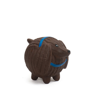 Side view of brown dachshund with blue collar squeaky latex ball dog toy.