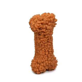 Close up image of the furry orange dog bone.