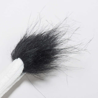 Close up of black, hairy tip of tail