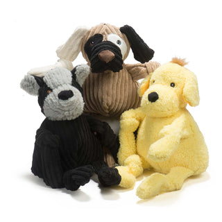 Set of three dog shaped, plush dog toys: brown furred plush with different furred patches, a yellow furred plush with golden brown hair, and a black and gray furred plush. 