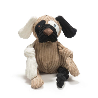 Dog shaped plush dog toy: has brown fur, with white furred right ear, black furred left ear, black fur on right outer-eye, white fur on left outer-eye, black lips, brown nose, white right arm, black left leg, and has knotted limbs. 