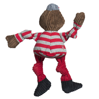Back of Ohio State University, Brutus the Buckeye plush dog toy: has red and gray hat, brown head, red and gray striped sweatshirt, brown hands, red pants, black shoes, and knotted limbs.  