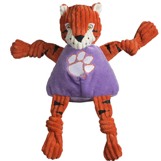 Clemson University the Tiger durable plush corduroy dog toy with knotted limbs, orange fur with black tiger stripes, white inner-ear, white outer-eye with yellow eyes and white pupils, black nose, white mouth, and is wearing a purple shirt with the university logo on the chest. Size large.
