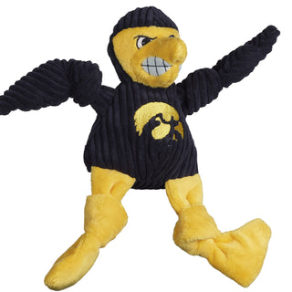 University of Iowa Herky the Hawk plush dog toy: has navy blue fur, yellow furred face, black eyes, white pupils, plush-out yellow beak, white teeth, navy blue furred body, arms and furred legs, and is squeaky with knotted limbs.
