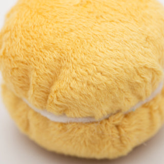 Close up of yellow ma-cat-a-roonie cat toy to show fabric texture.