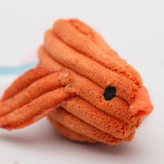 Close up image of orange chick to show corduroy and embroidery texture.