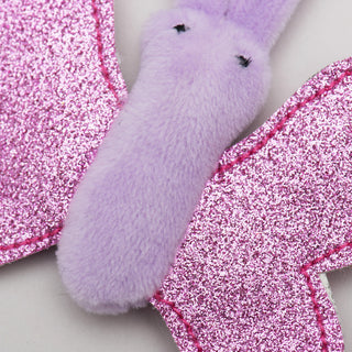 Close up image of butterfly shaped catnip stuffed cat toy to show detail of sparkly wings and purple fabric.