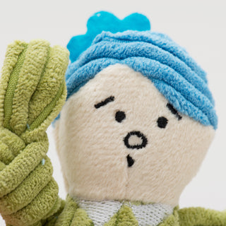 Close up of tiny plush corduroy dog toy groomer face with blue hair