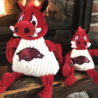 Large and small University of Arkansas Tusk the Razorback red boar mascot durable plush corduroy dog toys with knotted limbs.