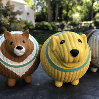 Set of three squeaky latex ball dog toys: grey poodle with orange collar, yellow golden retriever with blue collar, and brown and white collie with green collar. Poodle mostly out of frame.