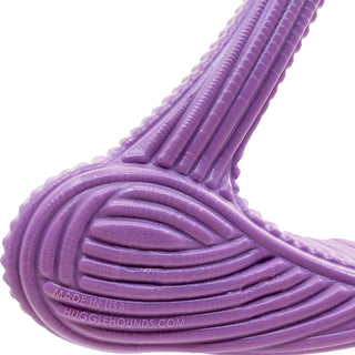 Close up of purple bone dog chew toy to show textured ridges all throughout the toy resembling corduroy texture.