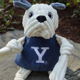 Yale University Handsome Dan white bulldog with grey ears mascot durable plush corduroy dog toy with knotted limbs wearing navy blue shirt and Yale University logo on the front.