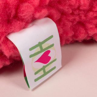 Close up image of the HuggleHounds® tag that's on the dog bone. 